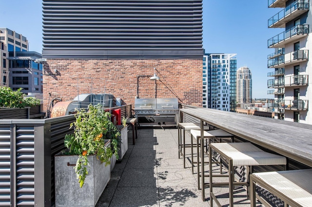 balcony with grilling area and a city view