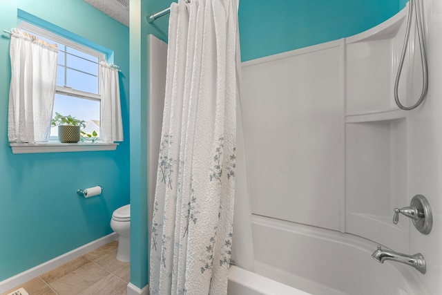 full bath with shower / bath combo, tile patterned flooring, baseboards, and toilet