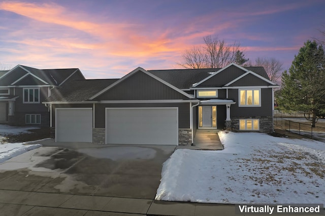 view of front of house with a garage, stone siding, and driveway