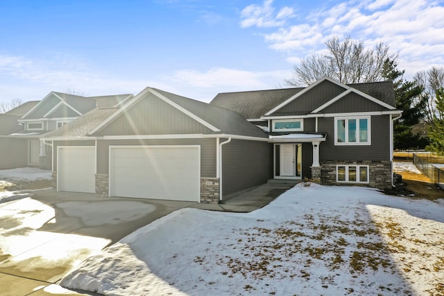 view of front of property featuring stone siding, roof with shingles, and an attached garage