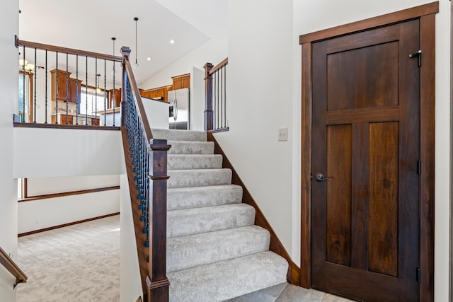 stairway with lofted ceiling, baseboards, carpet flooring, and recessed lighting