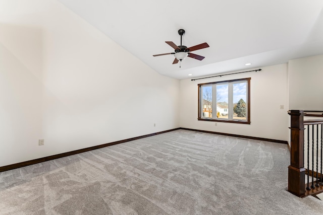 carpeted spare room featuring vaulted ceiling, ceiling fan, recessed lighting, and baseboards