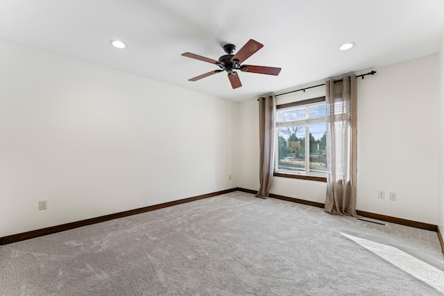 empty room with ceiling fan, recessed lighting, light carpet, visible vents, and baseboards