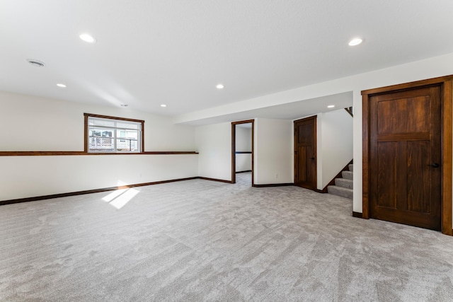 unfurnished room featuring stairs, recessed lighting, baseboards, and light colored carpet