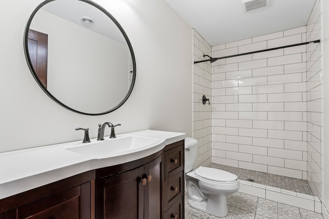 bathroom featuring toilet, a stall shower, visible vents, and vanity