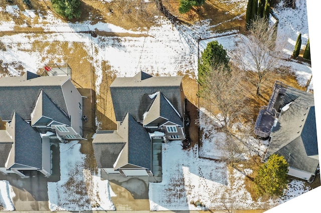 snowy aerial view with a residential view