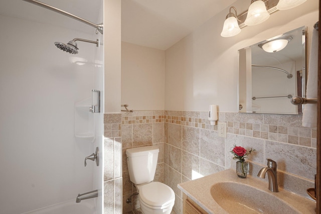 bathroom featuring a shower, tile walls, toilet, and vanity