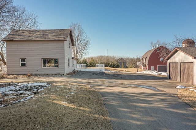 exterior space featuring a detached garage and an outdoor structure