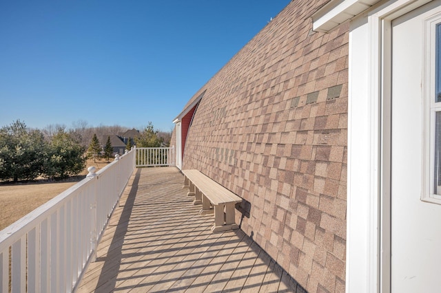 view of side of property with roof with shingles