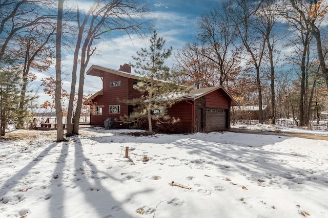 view of front of home featuring a garage and a chimney