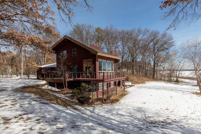 view of front of property with a chimney and a wooden deck