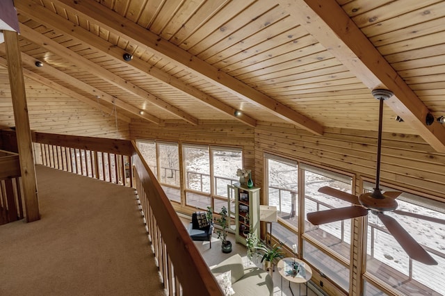 corridor with wooden ceiling, wood walls, carpet, and lofted ceiling with beams