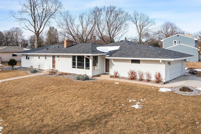 ranch-style home featuring a garage, driveway, a chimney, and a front yard