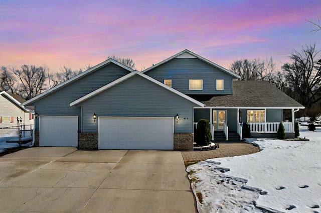 traditional-style house featuring a garage, covered porch, brick siding, and concrete driveway