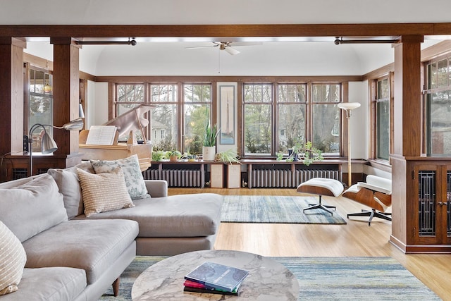 sunroom / solarium with radiator heating unit and a ceiling fan