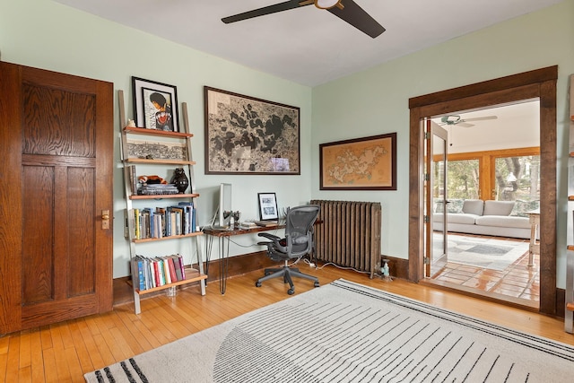 office with ceiling fan, hardwood / wood-style floors, and radiator