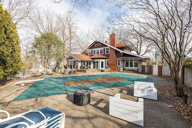 view of swimming pool featuring a diving board, a patio, fence, and a fenced in pool