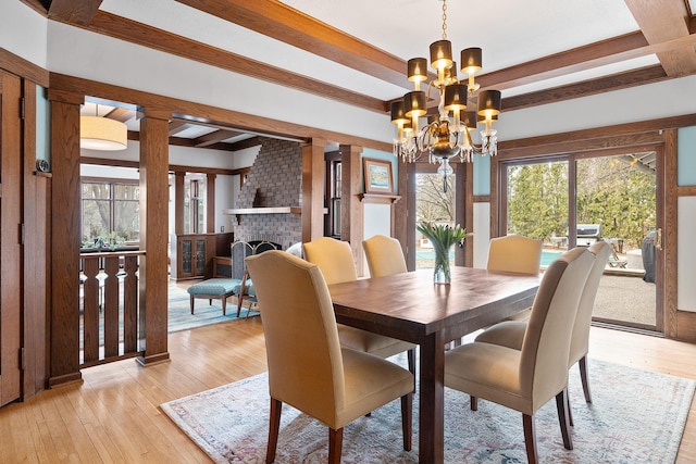 201 2nd St, Excelsior, MN 55331 - dining room featuring a chandelier, light wood-type flooring, beam ceiling, and a fireplace