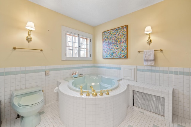 201 2nd St, Excelsior, MN 55331 - bathroom with tile patterned floors, a tub with jets, wainscoting, toilet, and tile walls