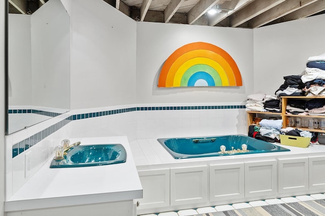 201 2nd St, Excelsior, MN 55331 - full bathroom featuring a sink, a wainscoted wall, tile walls, and a garden tub