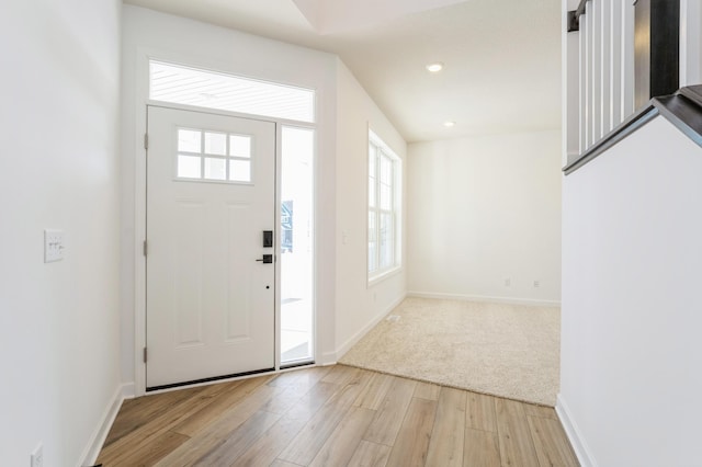 foyer with light wood-type flooring, baseboards, and recessed lighting