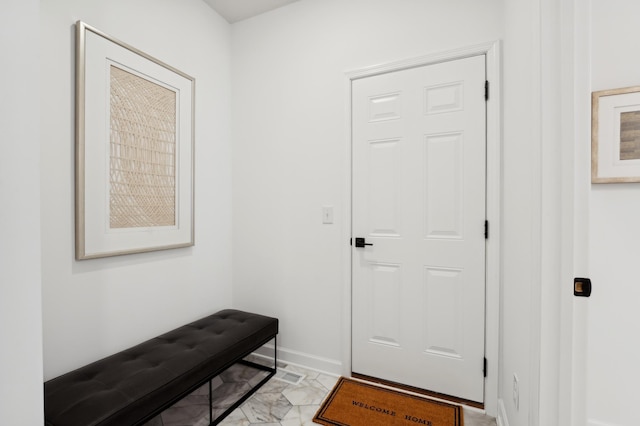 doorway to outside with baseboards