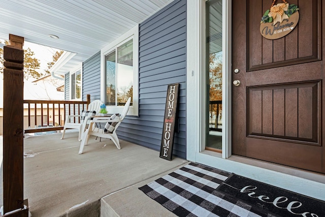 view of exterior entry with covered porch