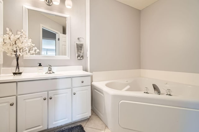 bathroom featuring a garden tub, tile patterned floors, and vanity