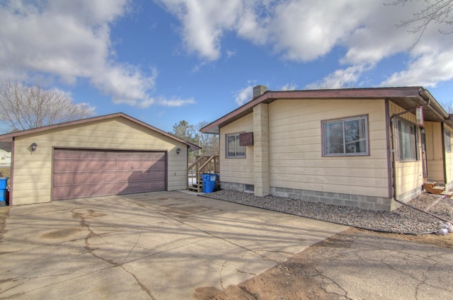 view of side of property featuring a garage and an outbuilding