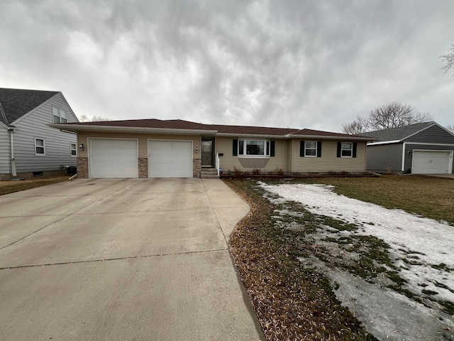 ranch-style home featuring an attached garage and concrete driveway