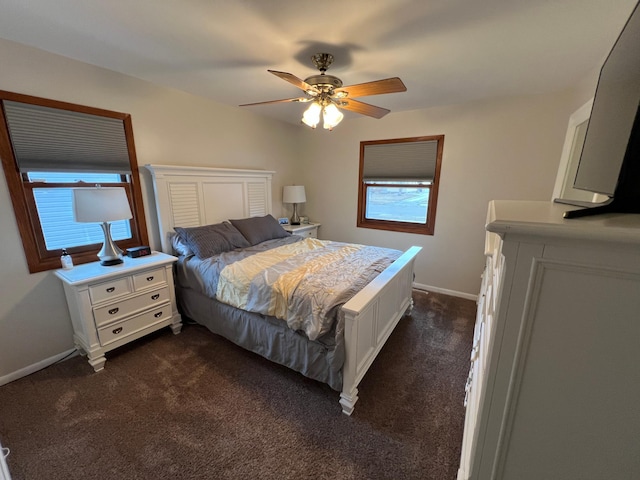 bedroom featuring a ceiling fan, dark carpet, and baseboards