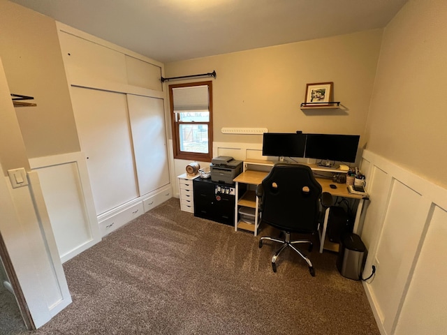 office space with carpet floors, a wainscoted wall, and a decorative wall