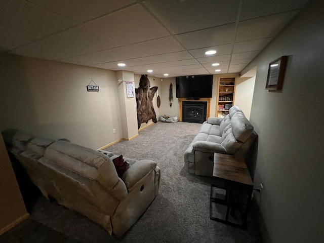 carpeted living area with recessed lighting, a fireplace, a paneled ceiling, and baseboards