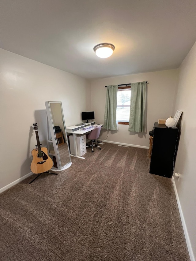 office space featuring baseboards and dark carpet