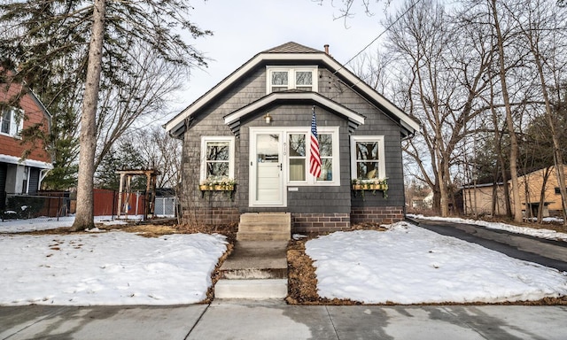 bungalow-style home with fence