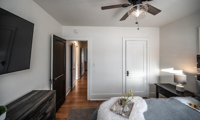 bedroom with wood finished floors, baseboards, and ceiling fan