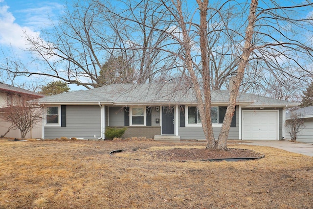 single story home featuring a garage, concrete driveway, and brick siding