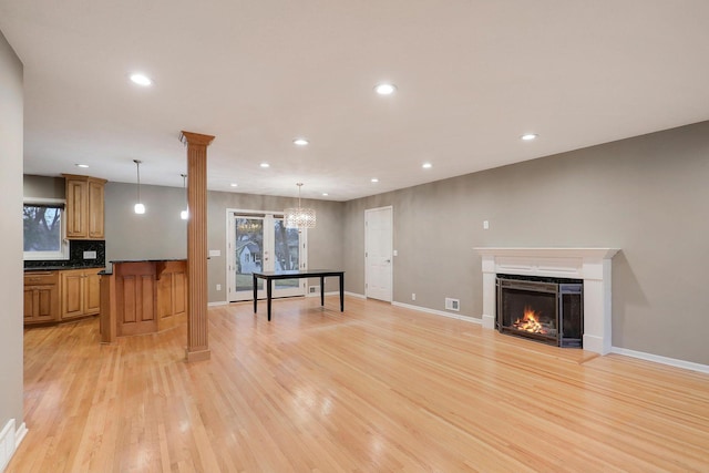 unfurnished living room featuring baseboards, light wood finished floors, recessed lighting, and visible vents