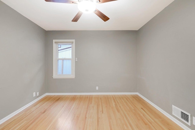 unfurnished room featuring baseboards, ceiling fan, light wood finished floors, and visible vents