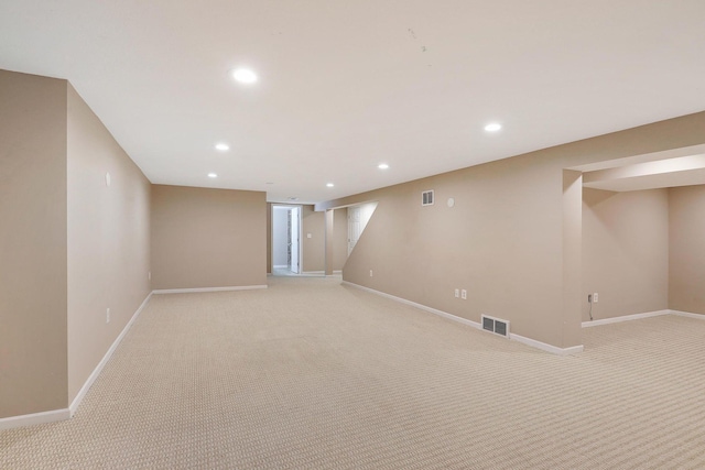 finished below grade area with baseboards, light colored carpet, recessed lighting, and visible vents