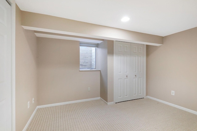 unfurnished bedroom featuring light colored carpet, recessed lighting, baseboards, and a closet
