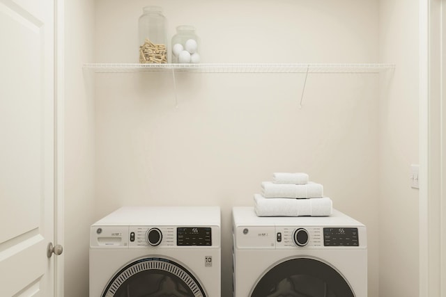 laundry area featuring washer and clothes dryer and laundry area