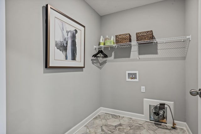 laundry room featuring baseboards, hookup for a washing machine, and laundry area