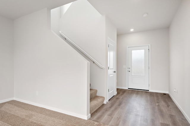 entryway with stairs, baseboards, wood finished floors, and recessed lighting