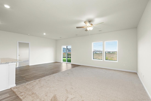 unfurnished room featuring recessed lighting, wood finished floors, a ceiling fan, and baseboards