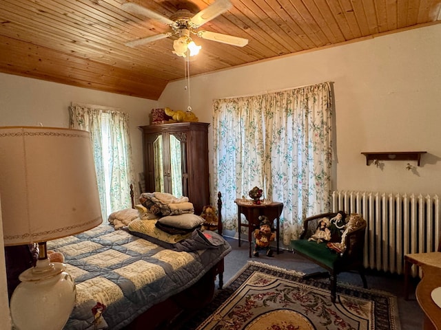 bedroom with lofted ceiling, wooden ceiling, a ceiling fan, radiator heating unit, and carpet