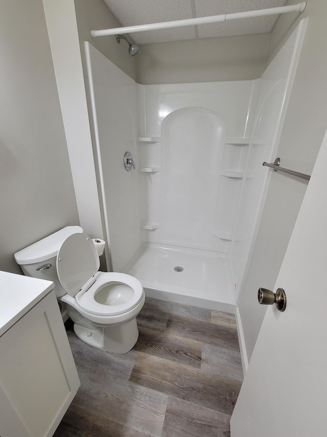 full bath with a shower, vanity, toilet, and wood finished floors