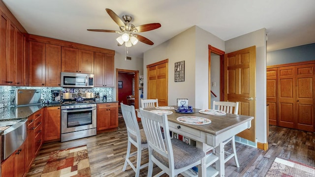 38184 County 47th Blvd, Goodhue, MN 55027 - kitchen with appliances with stainless steel finishes, light wood-style flooring, backsplash, ceiling fan, and brown cabinets