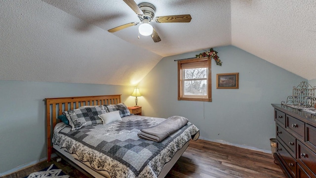 38184 County 47th Blvd, Goodhue, MN 55027 - bedroom with a textured ceiling, dark wood-style flooring, baseboards, vaulted ceiling, and a ceiling fan