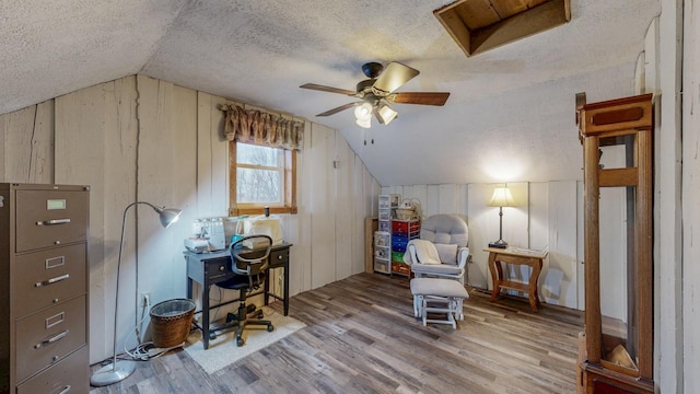 38184 County 47th Blvd, Goodhue, MN 55027 - office space featuring a textured ceiling, wood finished floors, lofted ceiling, ceiling fan, and wooden walls